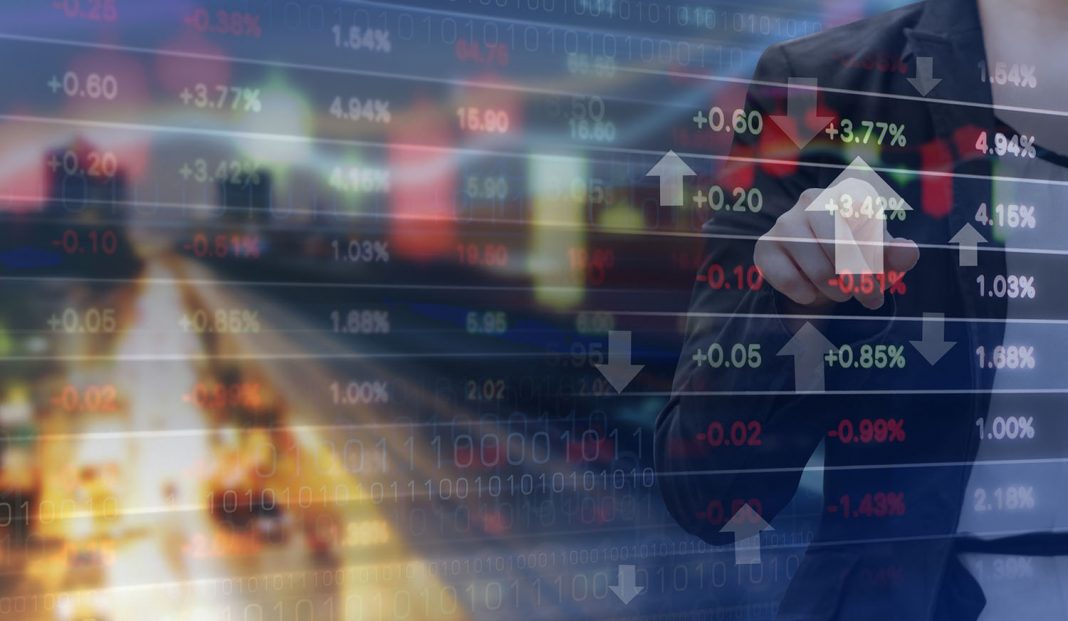 Double exposure of business woman and stock market graph